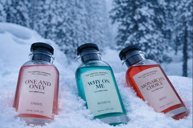Three perfume bottles labeled 'One and Only', 'Why on Me', and 'Monarch's Choice' in the snow.